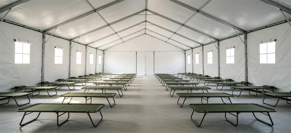Interior of emergency relief tent with folding beds for accommodation