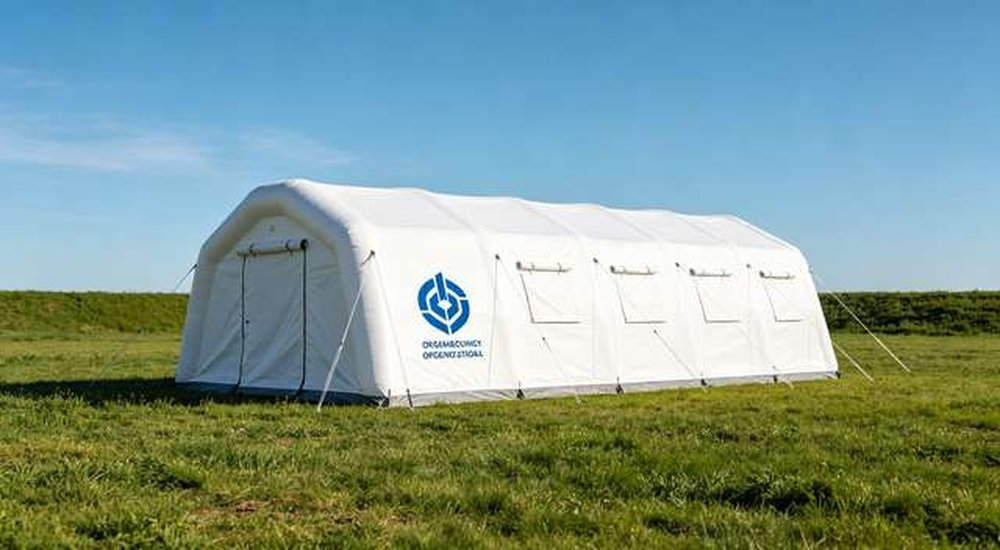 White inflatable emergency tent with printed blue organization logo outdoors, professional OEM custom branding for relief shelters, professional product photography