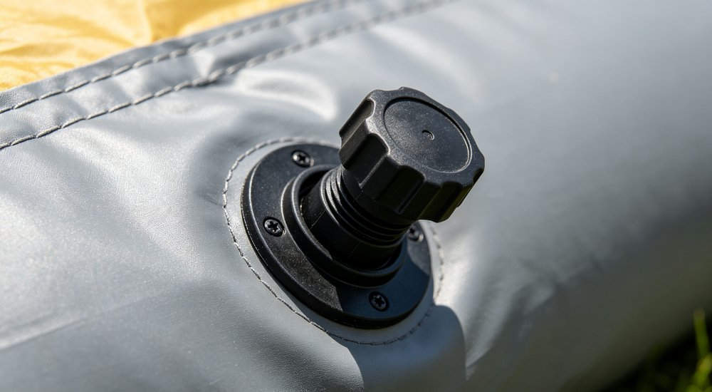 Air valve on inflatable isolation tent, close-up of inflation valve, bright lighting red and white inflatable emergency shelter for disaster relief operations