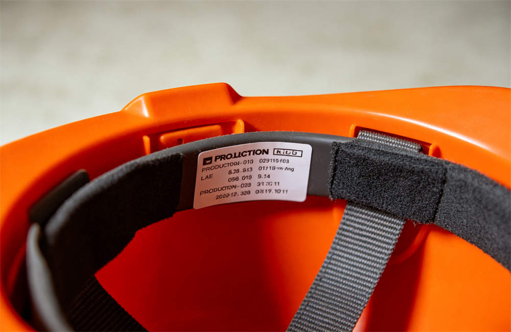 Close up of production date label inside safety helmet showing quality traceability for bulk buyers and importers today now now for bulk tornado emergency kit procurement and wholesale NGO relief orders today now