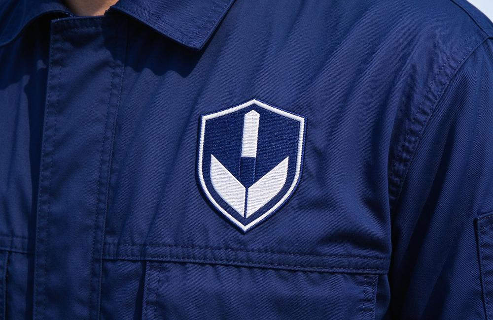 Close-up view of fR coveralls breathable fabric detail for flame resistant workwear comfort in hot conditions and fire resistant clothing wearing experience for flame resistant workwear buyers
