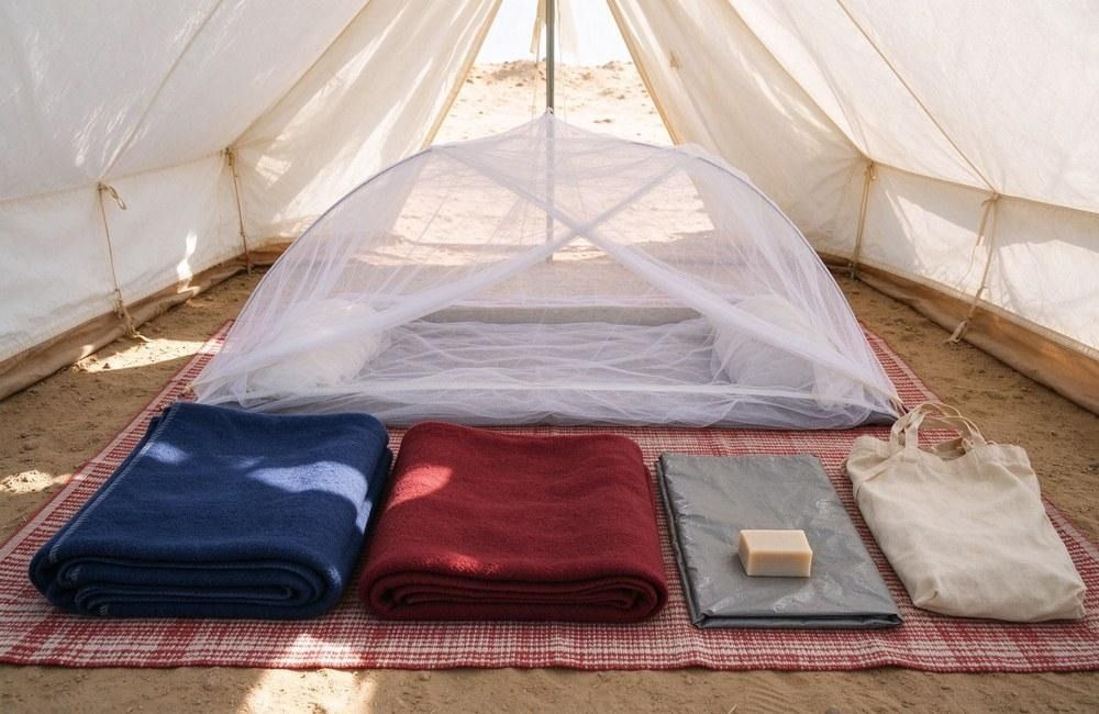 Sealed hygiene kit with soap, towel and menstrual items laid out beside a mosquito net on a bright table, showing relief nets and hygiene kit composition